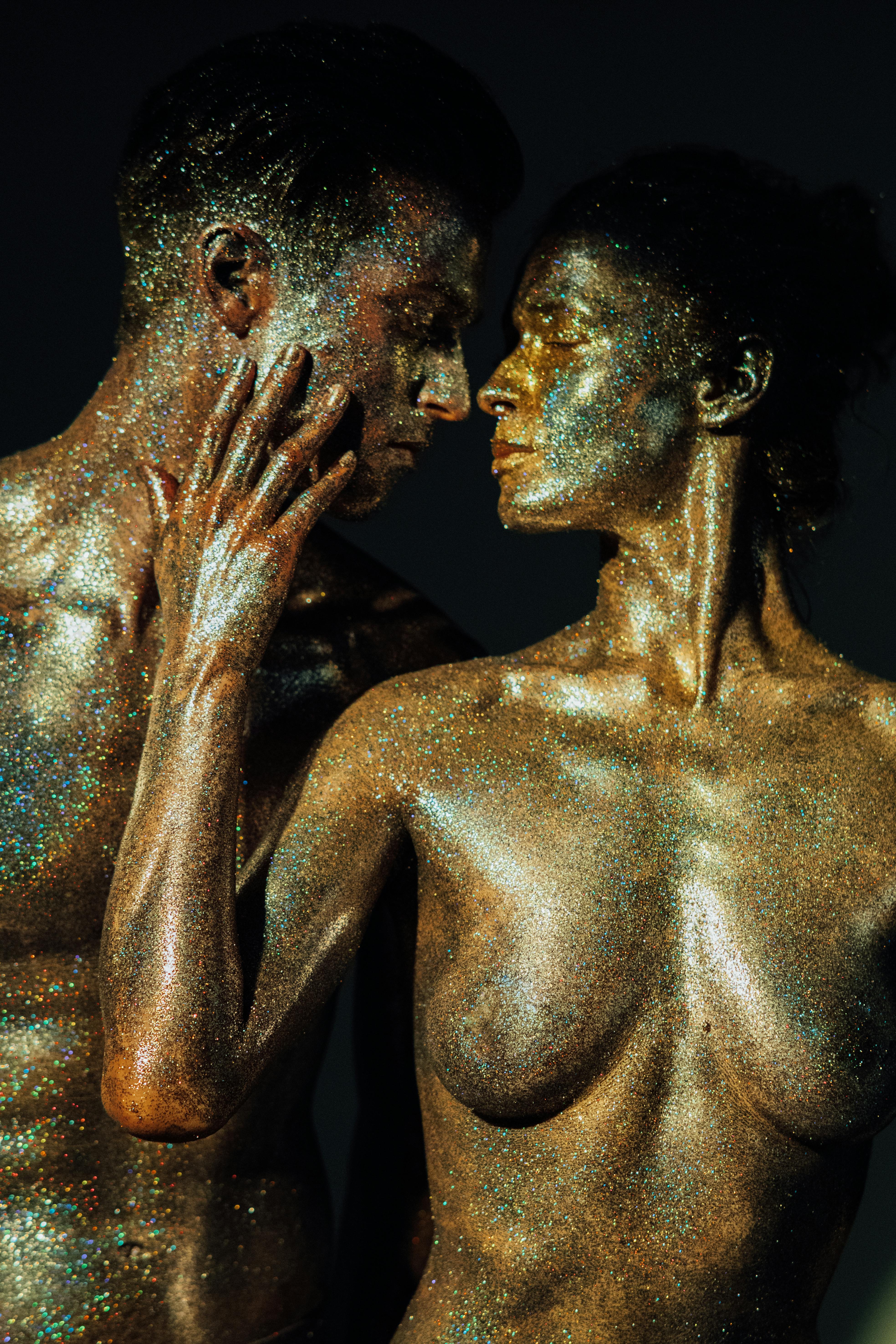 topless man and woman covered with glitters