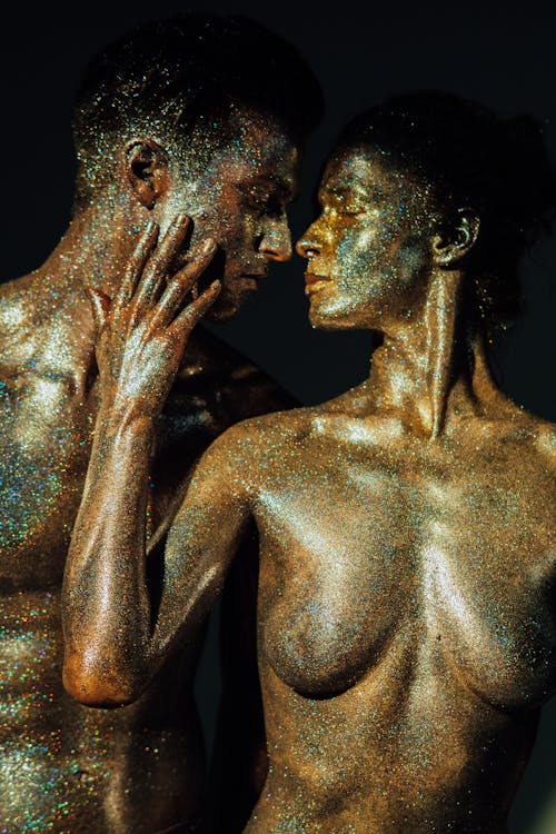 Topless Man and Woman Covered with Glitters
