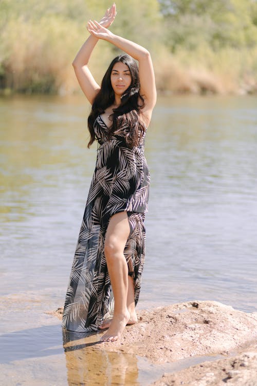 Woman in Dress Posing near Water