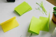A creative crafting scene with colorful paper and scissors on a desk.