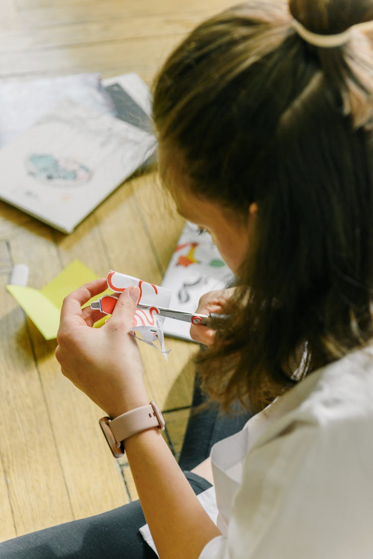 A Person Cutting Paper With Drawing