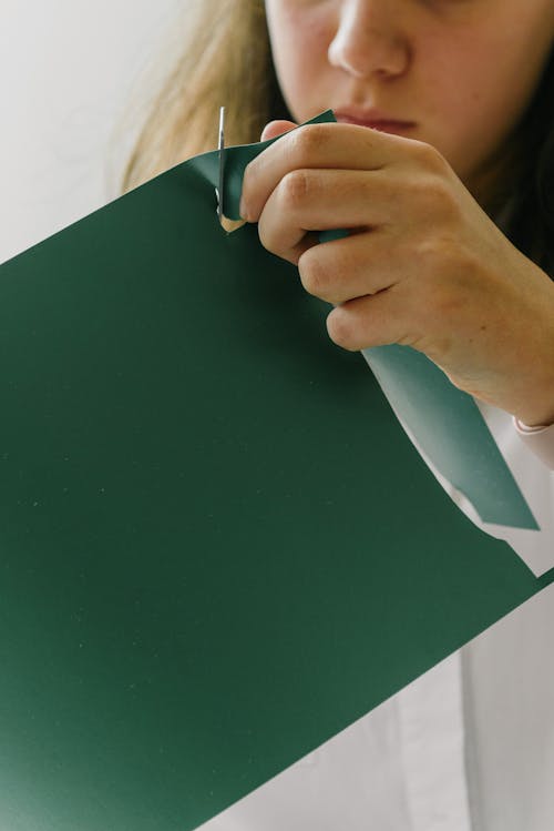 Person Cutting White Paper
