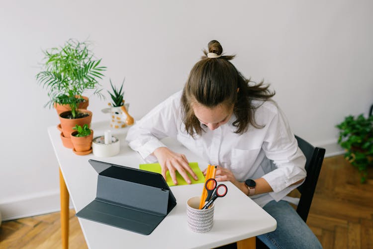 A Woman Folding A Paper