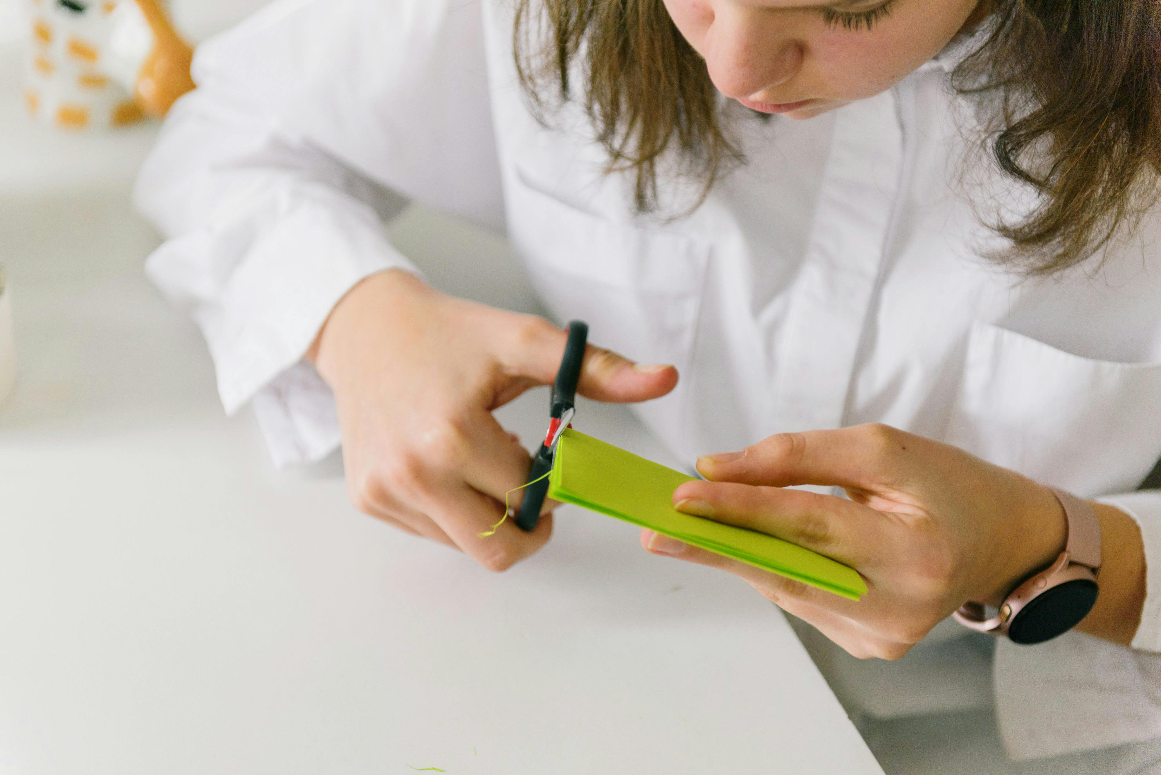 kid cutting a colored paper