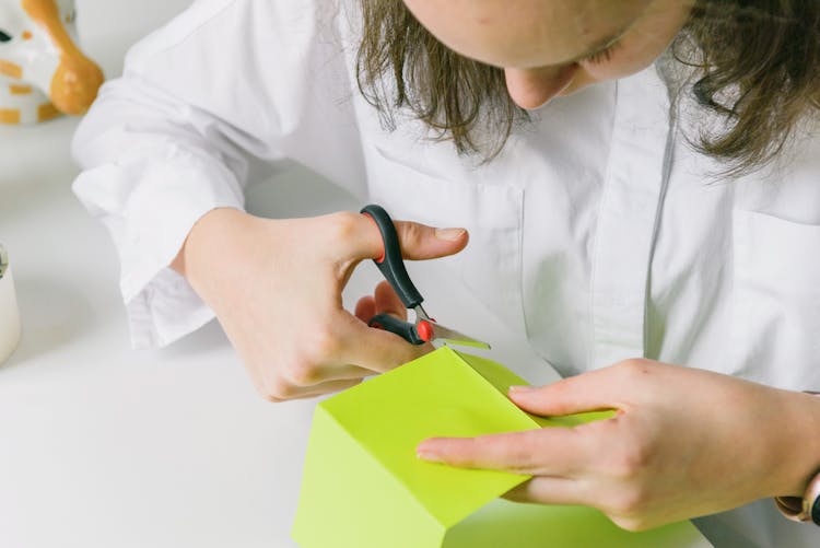 Girl Cutting Colorful Paper At Desk