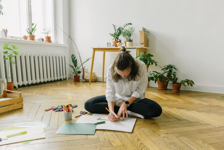 Woman Sitting On Floor And Drawing