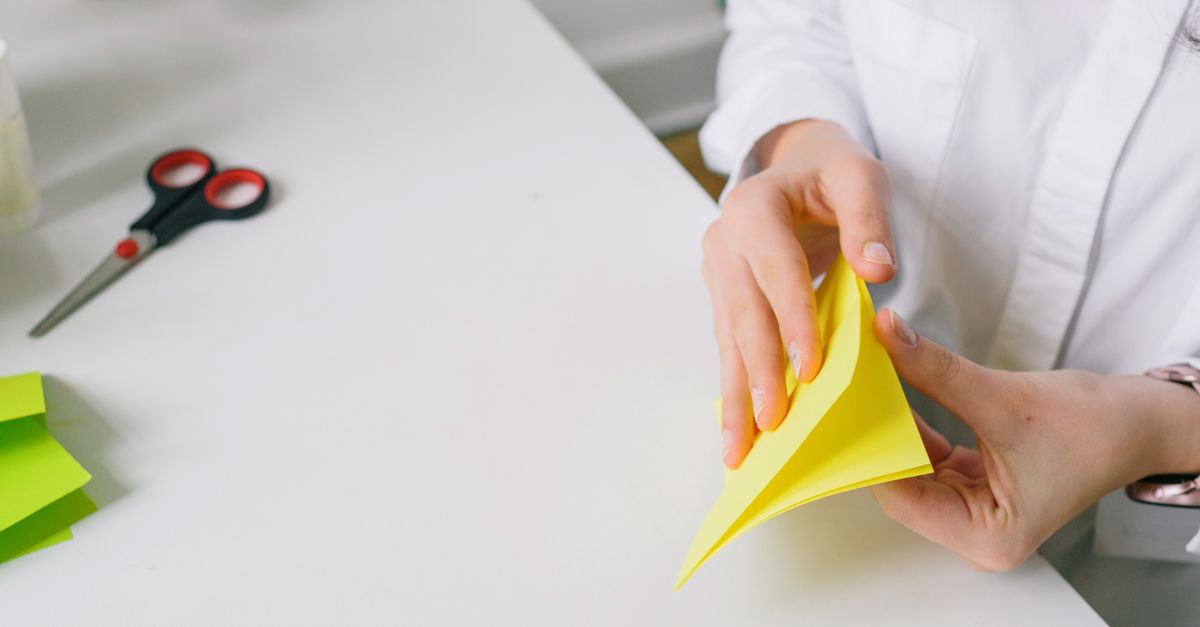 Close-up hands learning a simple magic trick or folding a paper crane