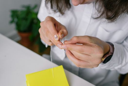 A Person Threading a Needle