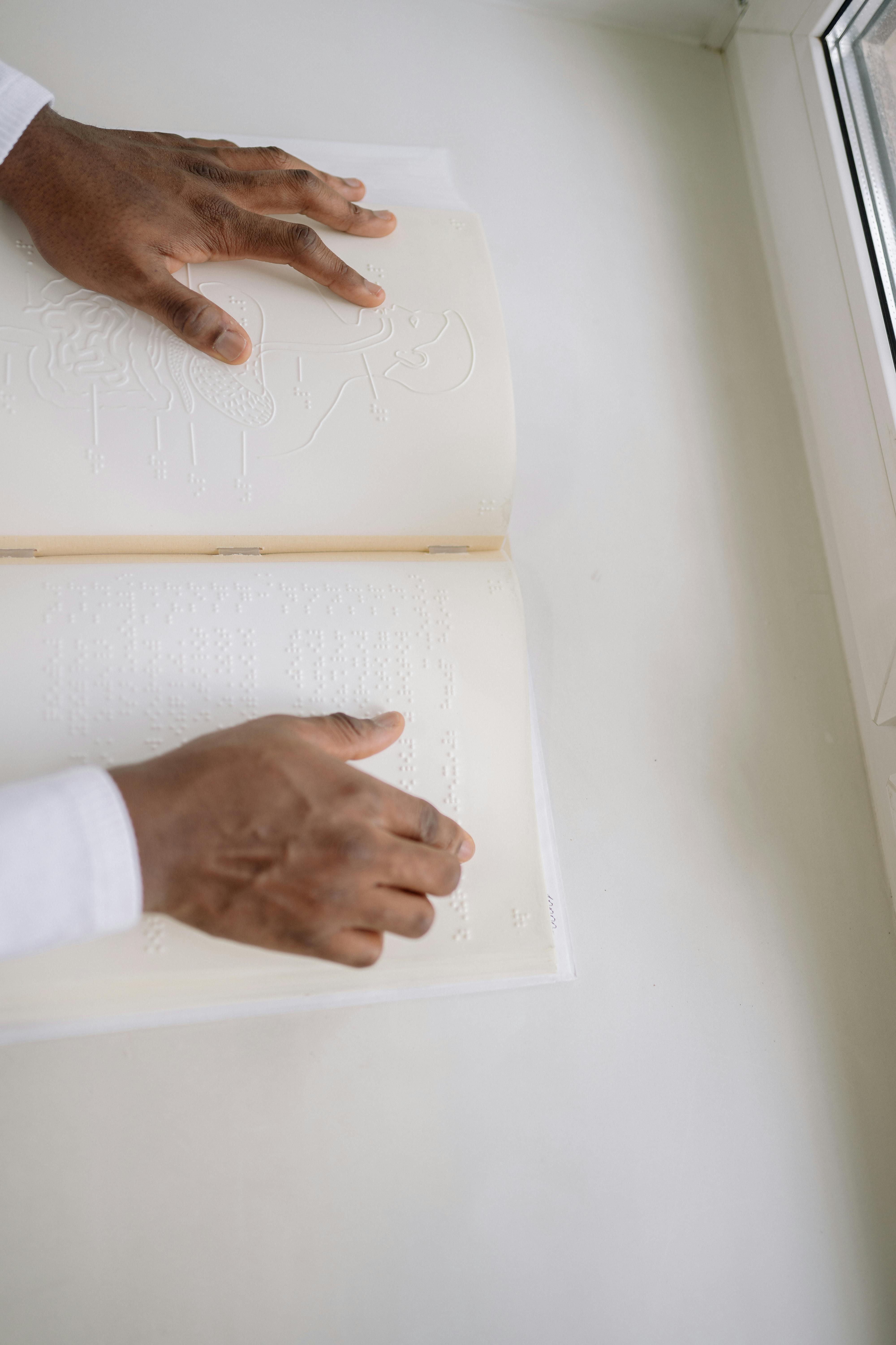 a person reading a braille book