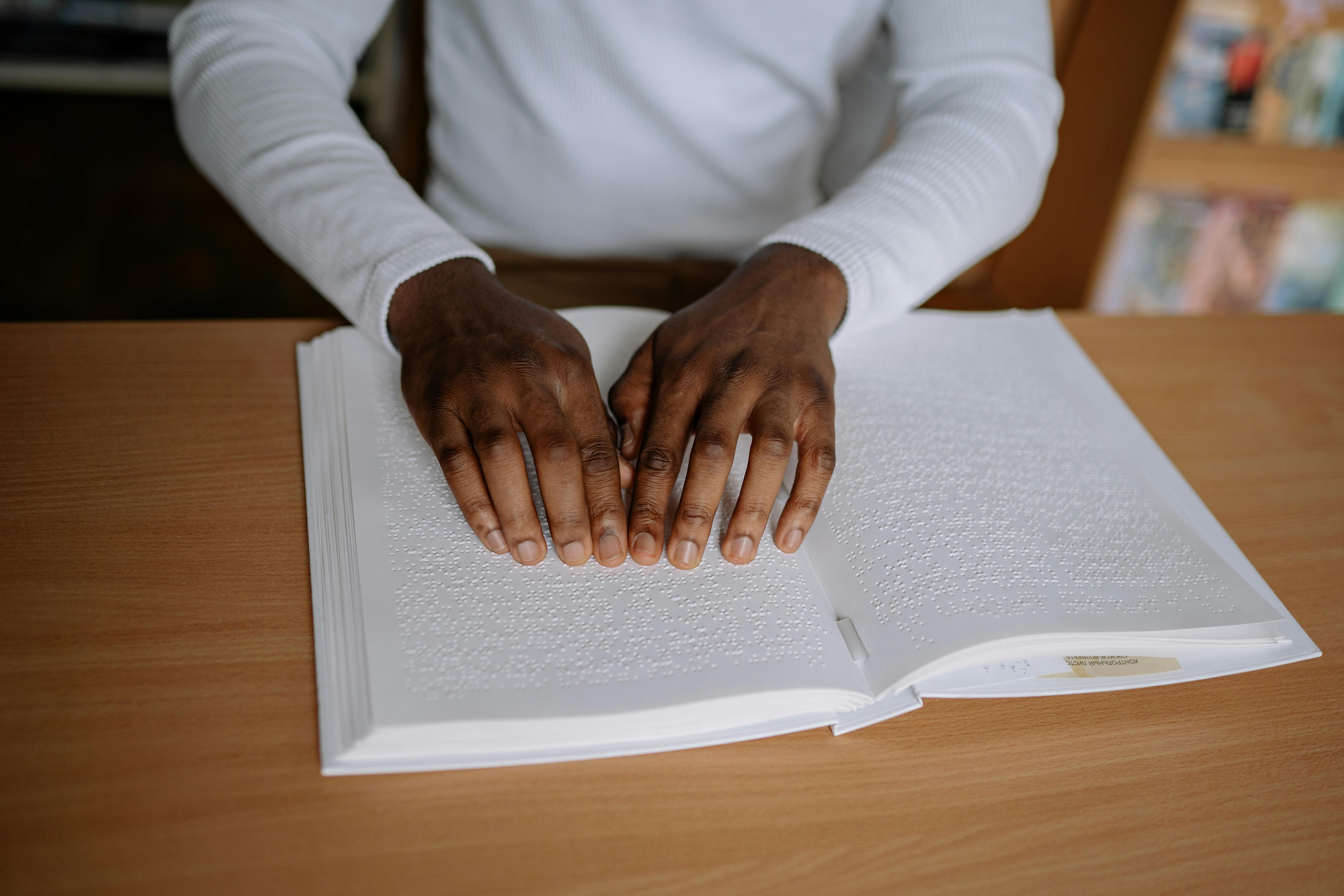 person in white long sleeve shirt holding a white paper