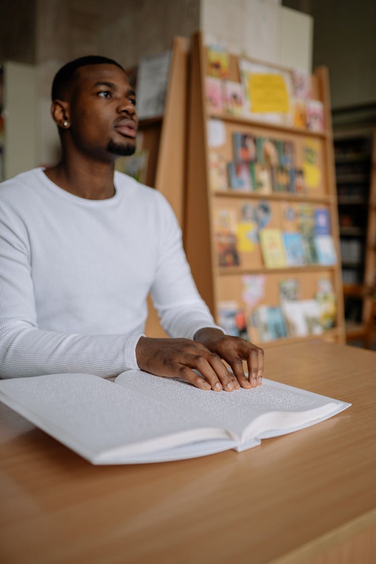 Man In White Long Sleeve Shirt Reading By Touch