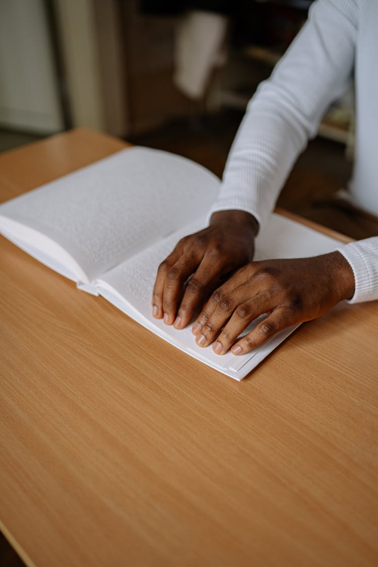 A Person Reading By Braille System