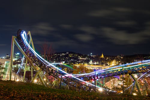 Free Time-lapse Photography Of Roller Coaster During Night Time Stock Photo
