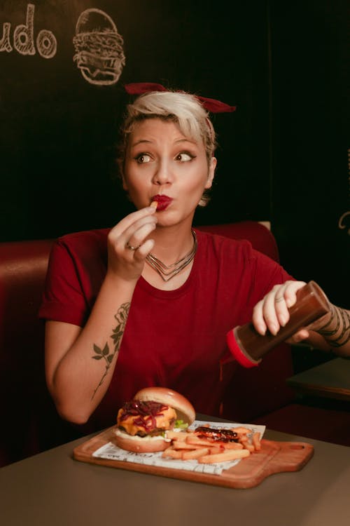 A Woman Eating French Fries