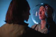 Back View of Person Writing on Transparent Ball on Model