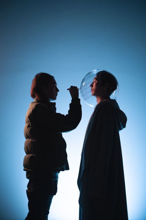 Free Captivating studio shot of two people interacting, creating artistic silhouettes. Stock Photo