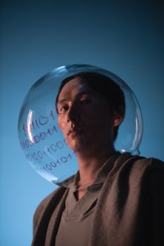 Conceptual portrait of a man with a transparent helmet displaying binary code.