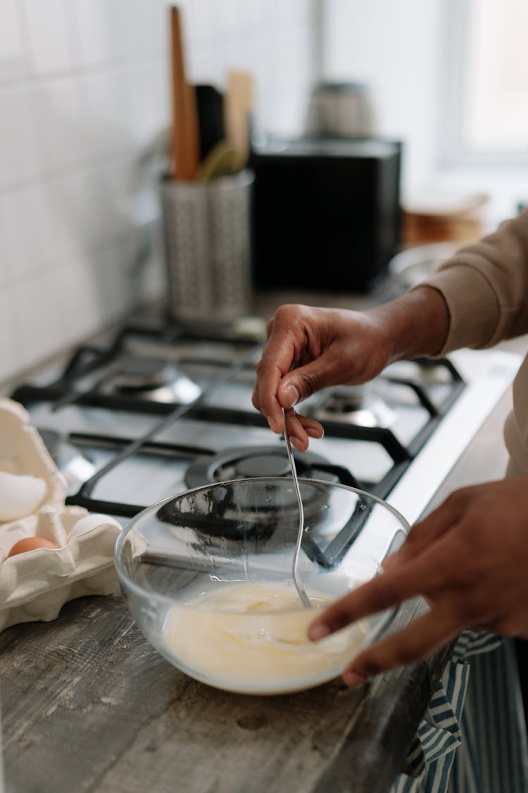 Person Stirring Egg On The Bowl