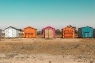 Colorful Wooden Houses on Brown Grass