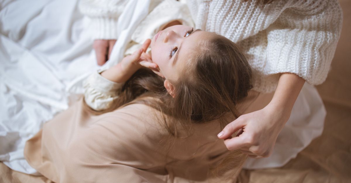 A serene image of a child lying on a mother's lap, capturing a tender and peaceful moment indoors.