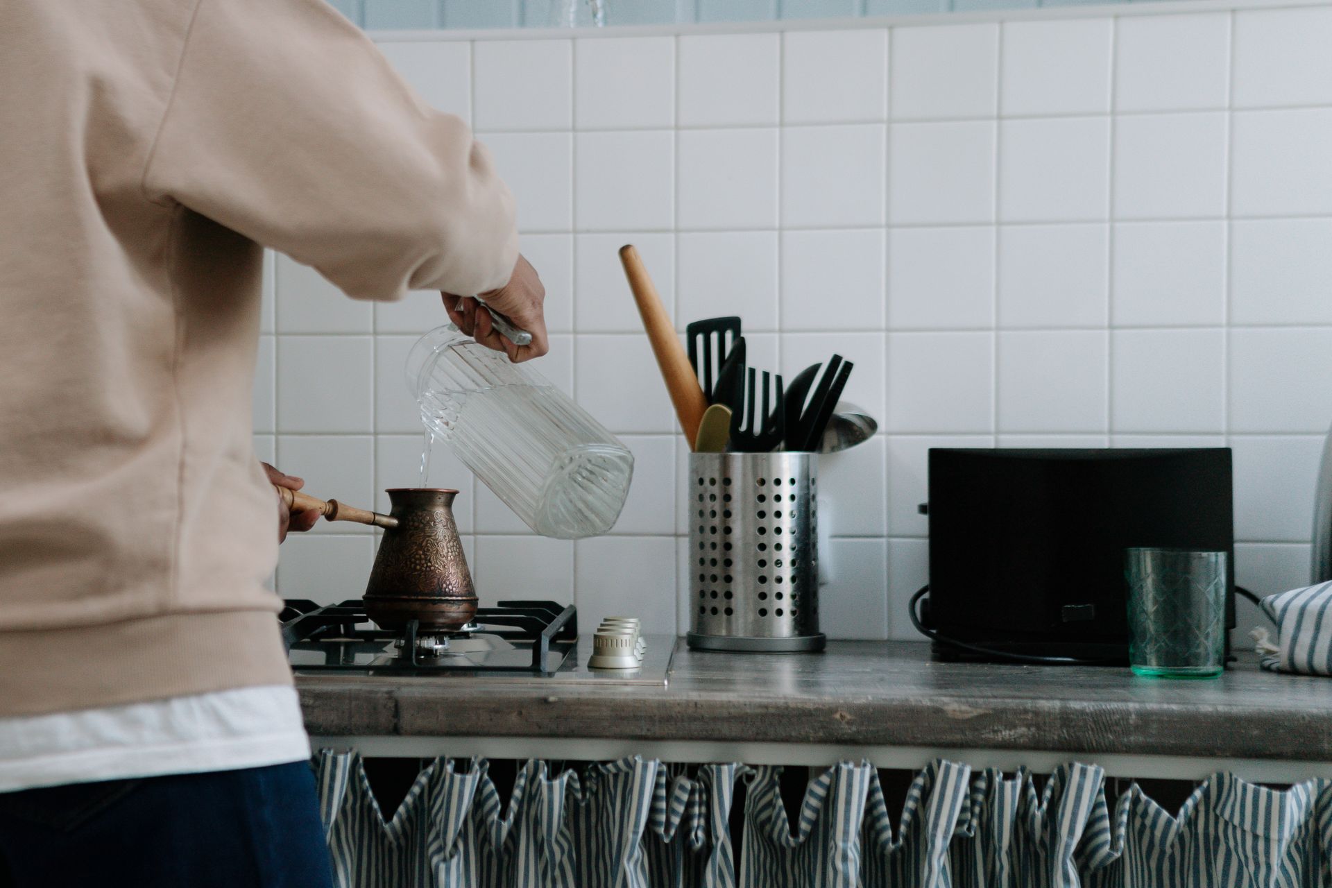 Man Making Coffee in Cezve on Stove at Home