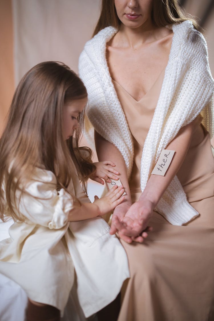 Mother And Daughter Playing On The Bed