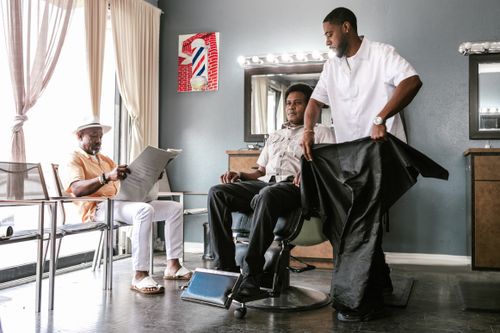 Stylist caping a client before a cut