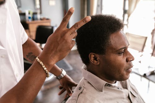 A Barber Checking a Client's Hair