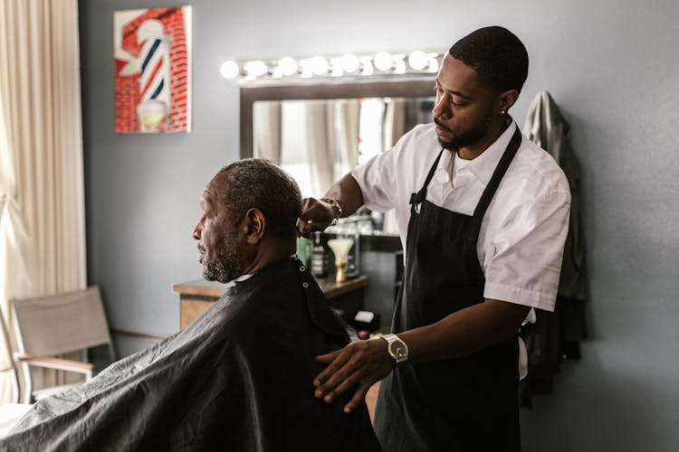 Barber Doing Haircut For Mature Black Customer 