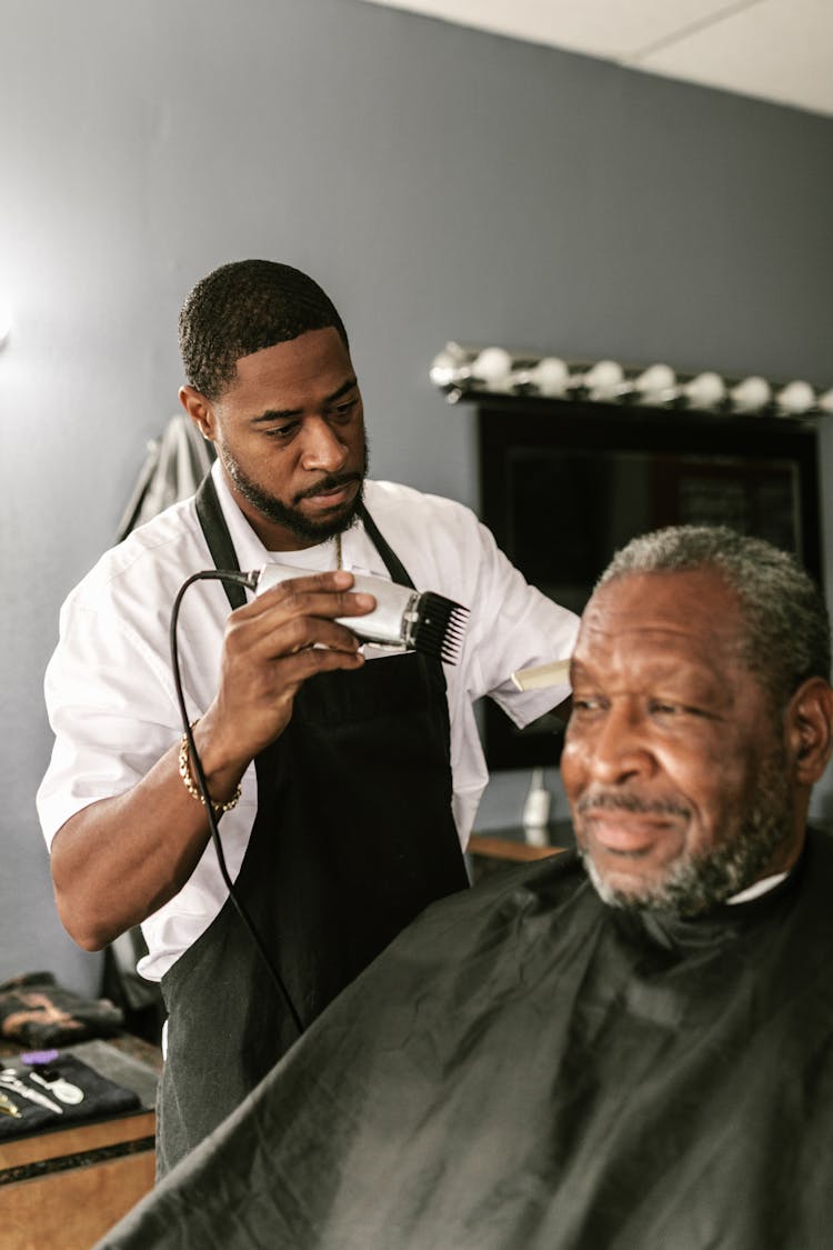 A Barber Holding A Hair Clipper 