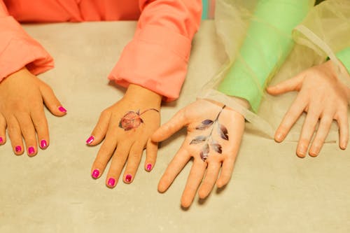 Hands of Women With Floral Removable Tattoos