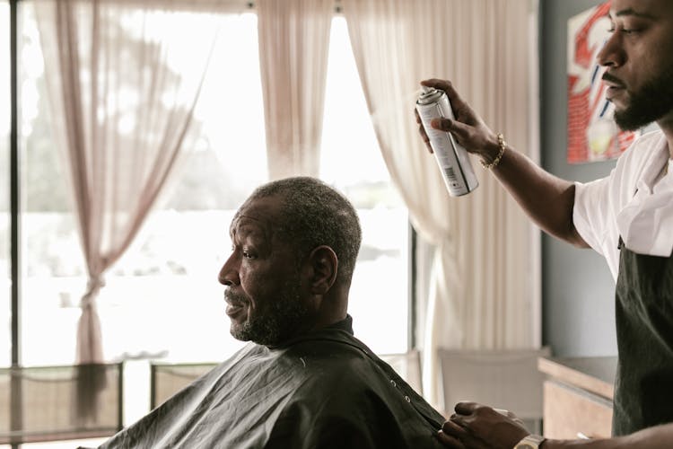 Hairdresser Using Hairspray 