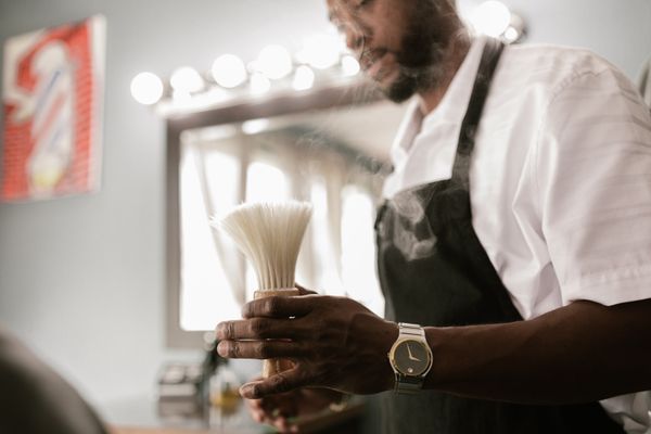 Barber holding brush