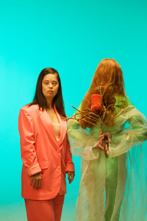Free Portrait of women in colorful outfits showcasing inclusive fashion against a teal background. Stock Photo