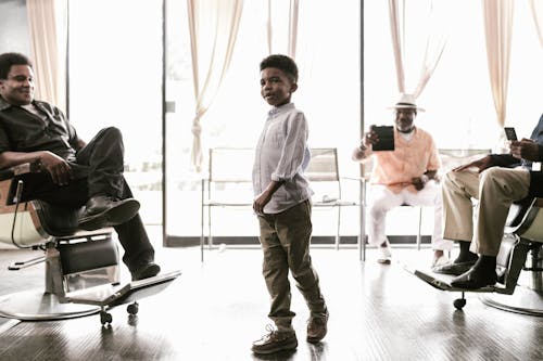 Free A Boy Standing at a Barber Shop Stock Photo