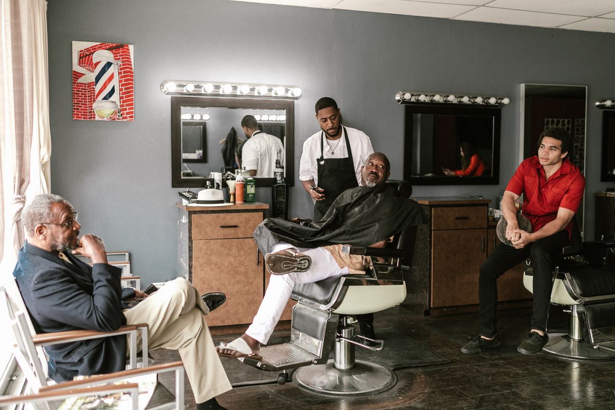 Barber working on a client in a barbershop