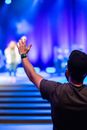 Anonymous viewer supporting musicians on stage