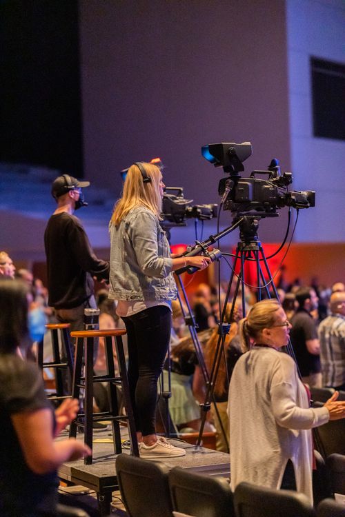 Free Side view of operators with cameras recording video during performance in concert room Stock Photo
