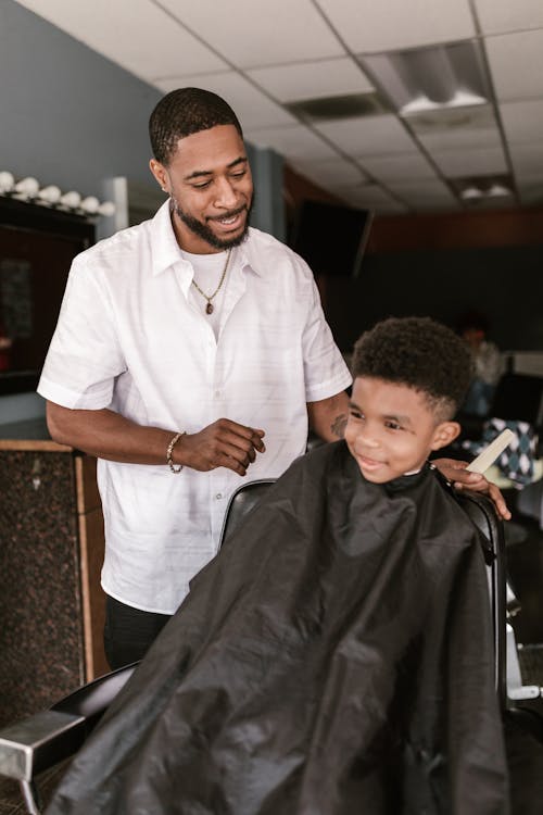 Man in White Button Up Shirt Talking to the Boy