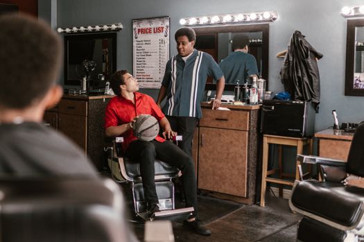 A bustling barbershop with customers engaged in conversation, surrounded by classic decor.
