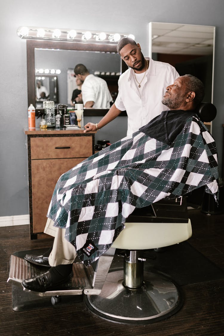 Mature Black Man Getting Haircut In Barbershop