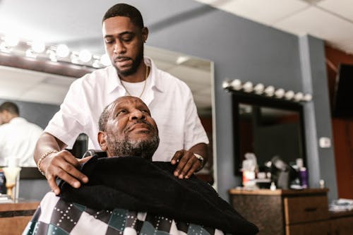 Free A Barber Preparing a Man for a Haircut Stock Photo