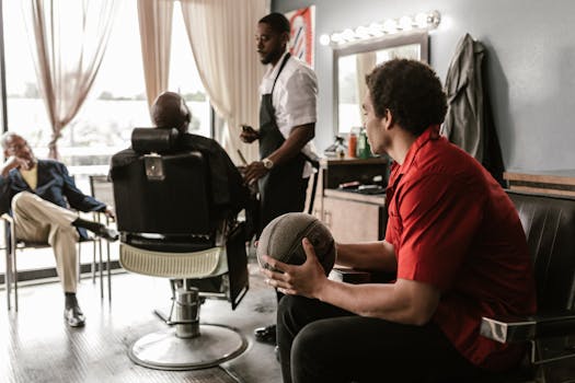 Men relaxing in a barber shop, holding a basketball, enjoying a casual day indoors.