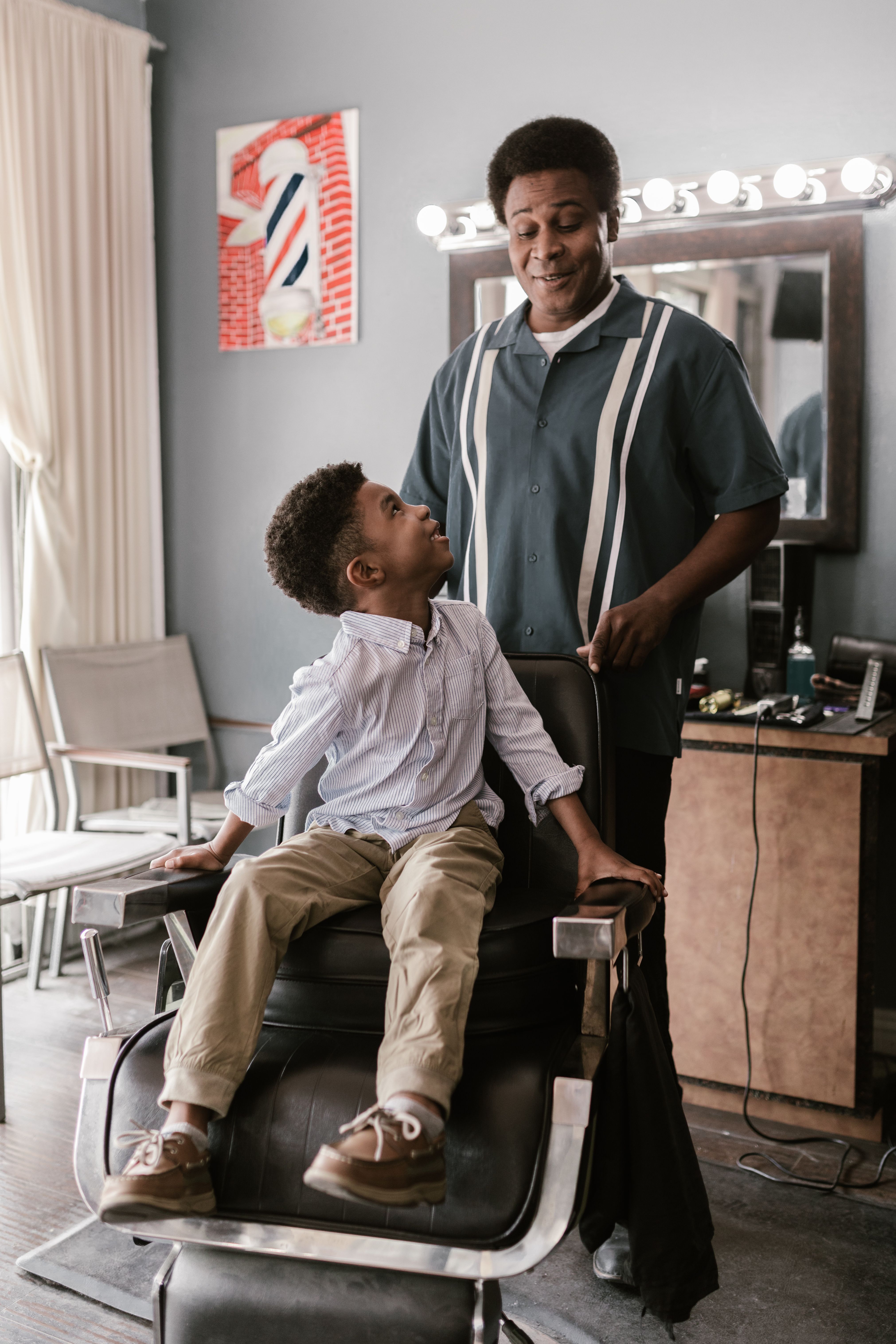A boy sitting on a barber chair