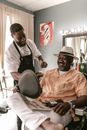 A Man in White Hat Sitting on a Barber's Chair