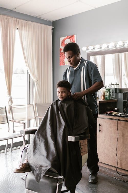 Boy in Cape at Hairdressers Salon