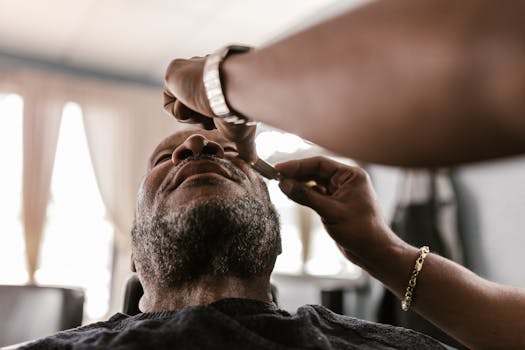 A serene moment during a beard trim in a barbershop, featuring skilled hands and focused attention.