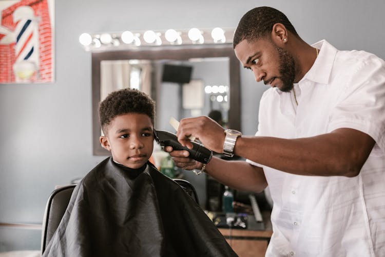 Barber Cutting A Boy's Hair