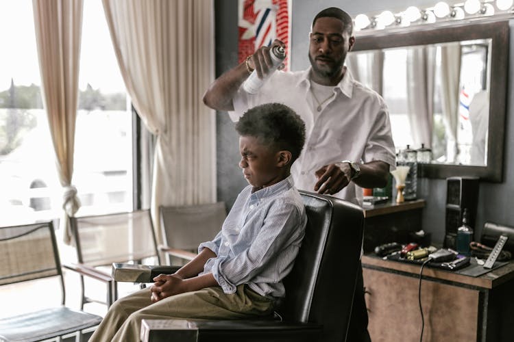 Hairdresser Using Hairspray On Boys Hair