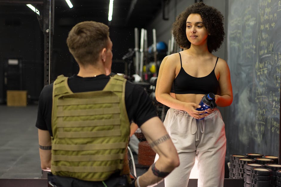 personal trainer discussing a workout plan with a client - is it ok to do full body workouts everyday personal trainer discussing a workout plan with a client - is it ok to do full body workouts everyday